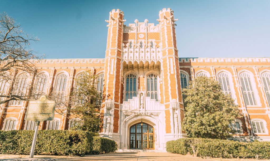 Beautiful Neo-Gothic architecture of the University of Oklahoma under a clear sky.