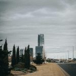 Scenic view of Oklahoma City skyline featuring the iconic Devon Tower under a cloudy sky.
